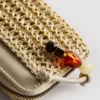 Billetera tejida con cremallera