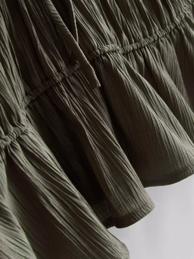 Blusa arrugada con lazo al frente