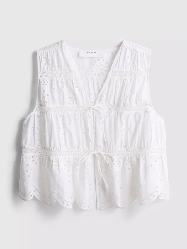 Blusa con broderie de algodón y lazo en el frente
