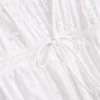 Blusa con broderie de algodón y lazo en el frente