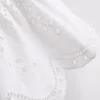 Blusa con broderie de algodón y lazo en el frente