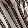 Camisa holgada con botones y dobladillo curvo