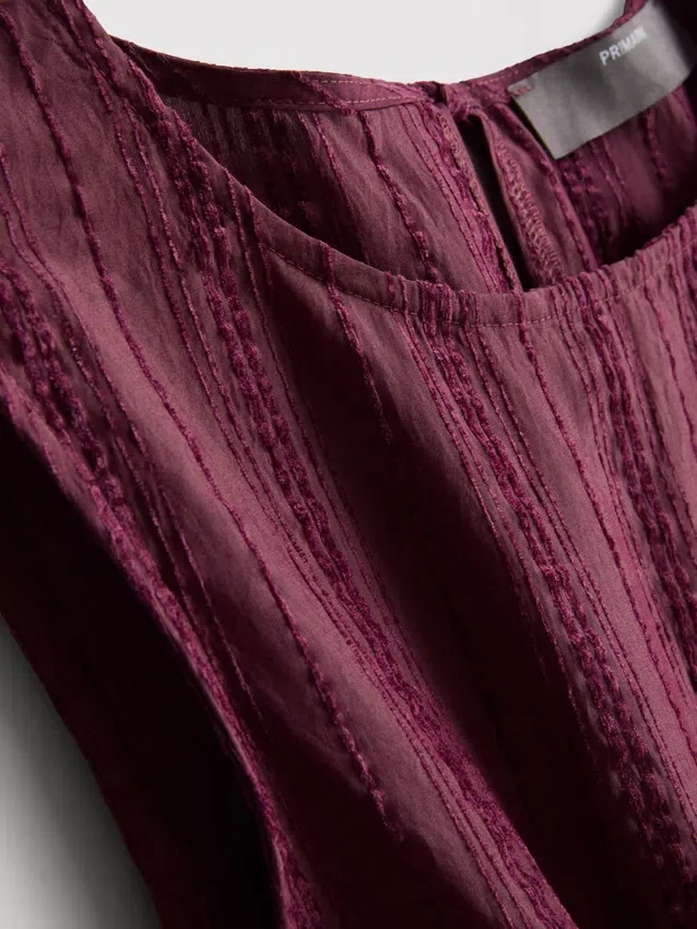 Camiseta sin mangas con dobladillo peplum a rayas