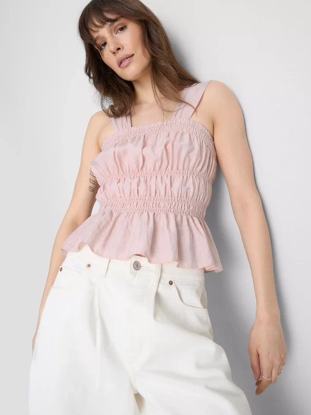 Camiseta sin mangas con dobladillo tipo peplum fruncido