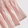 Camiseta sin mangas con dobladillo tipo peplum fruncido
