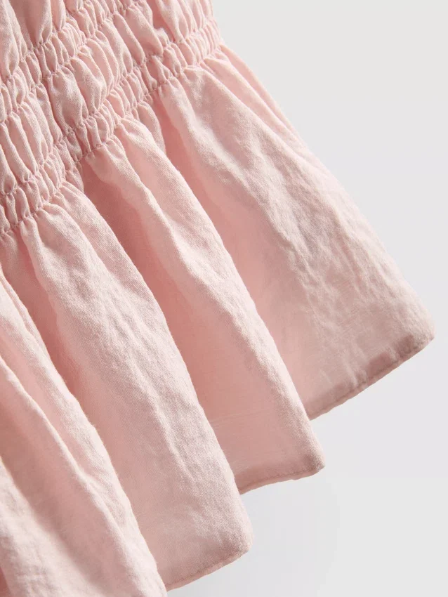 Camiseta sin mangas con dobladillo tipo peplum fruncido