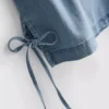 Camiseta sin mangas de mezclilla de algodón con lazos a los lados