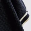 El polo con cremallera texturizada de The Edit