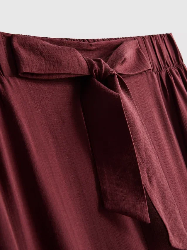 Pantalones palazzo con detalle de moño
