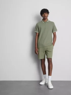 Polo con cuello con cremallera y textura