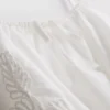 Top corto tipo camisola de algodón bordado