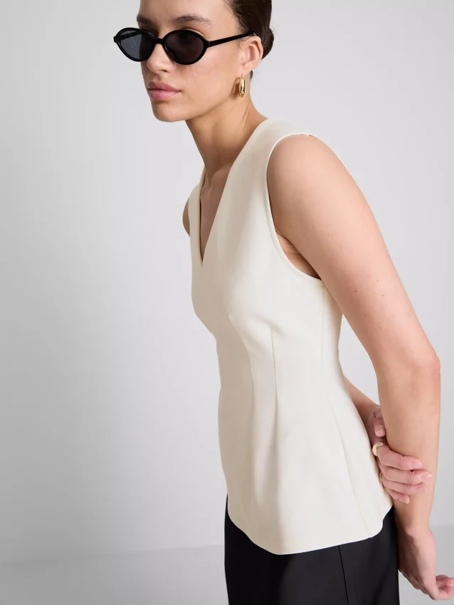 Top sin mangas con peplum y cuello en V