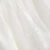 Top tipo camisola de algodón con bordado y dobladillo con volantes