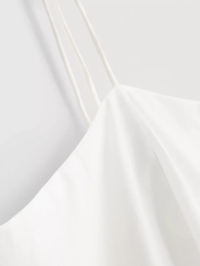 Top tipo camisola de algodón con bordado y dobladillo con volantes