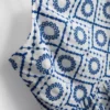Top tipo camisola de algodón con calados