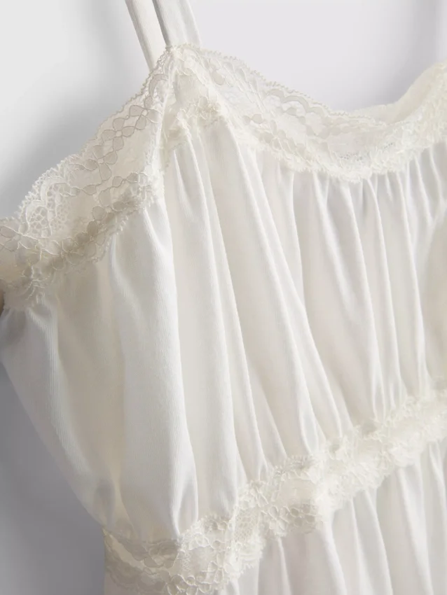 Top tipo camisola de algodón con dobladillo en forma de pañuelo